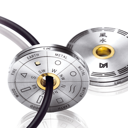 Meister - The coin-size feng shui disc in titanium and gold. Worn as a pendant or as a pocket tool