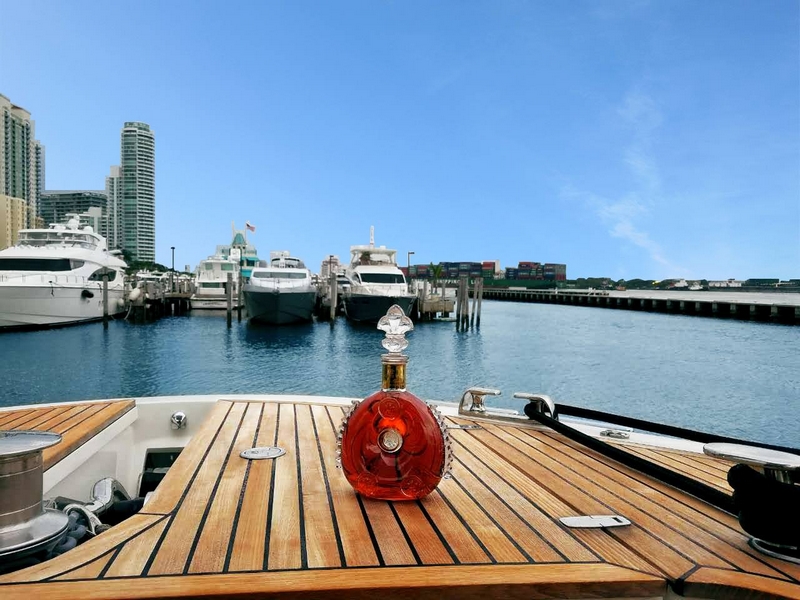 The LOUIS XIII decanter stands out against the deep blue sky of Miami