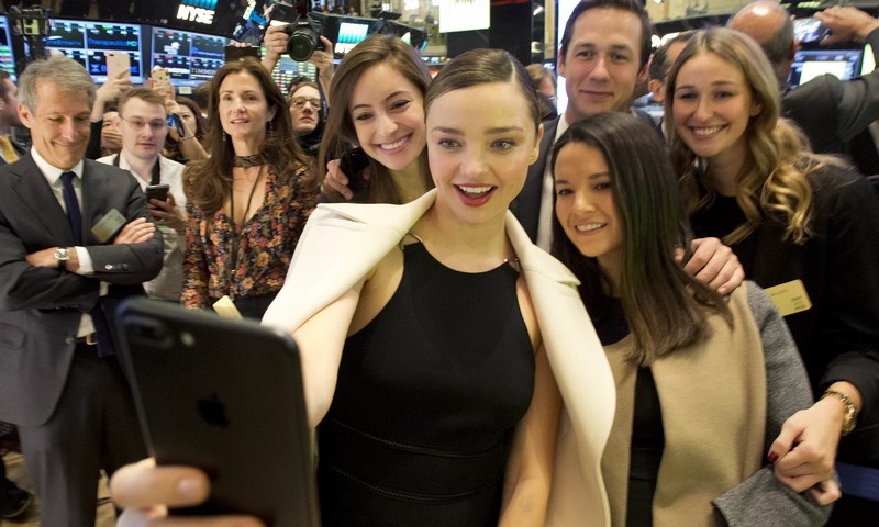 Model Miranda Kerr, centre, partner of Snapchat boss Evan Spiegel, takes a selfie at the launch of Snapchat on the New York Stock Exchange