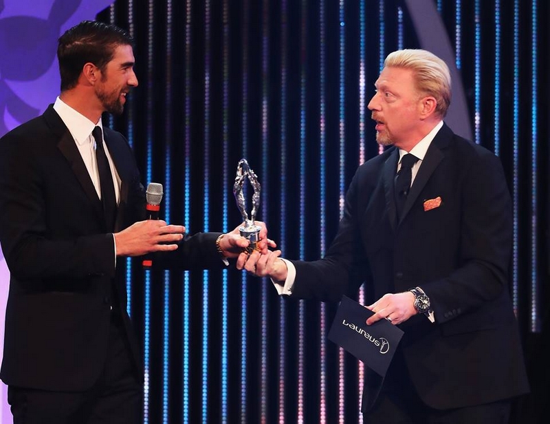Swimmer Michael Phelps of the US accepts his award from Laureus Academy member Boris Becker
